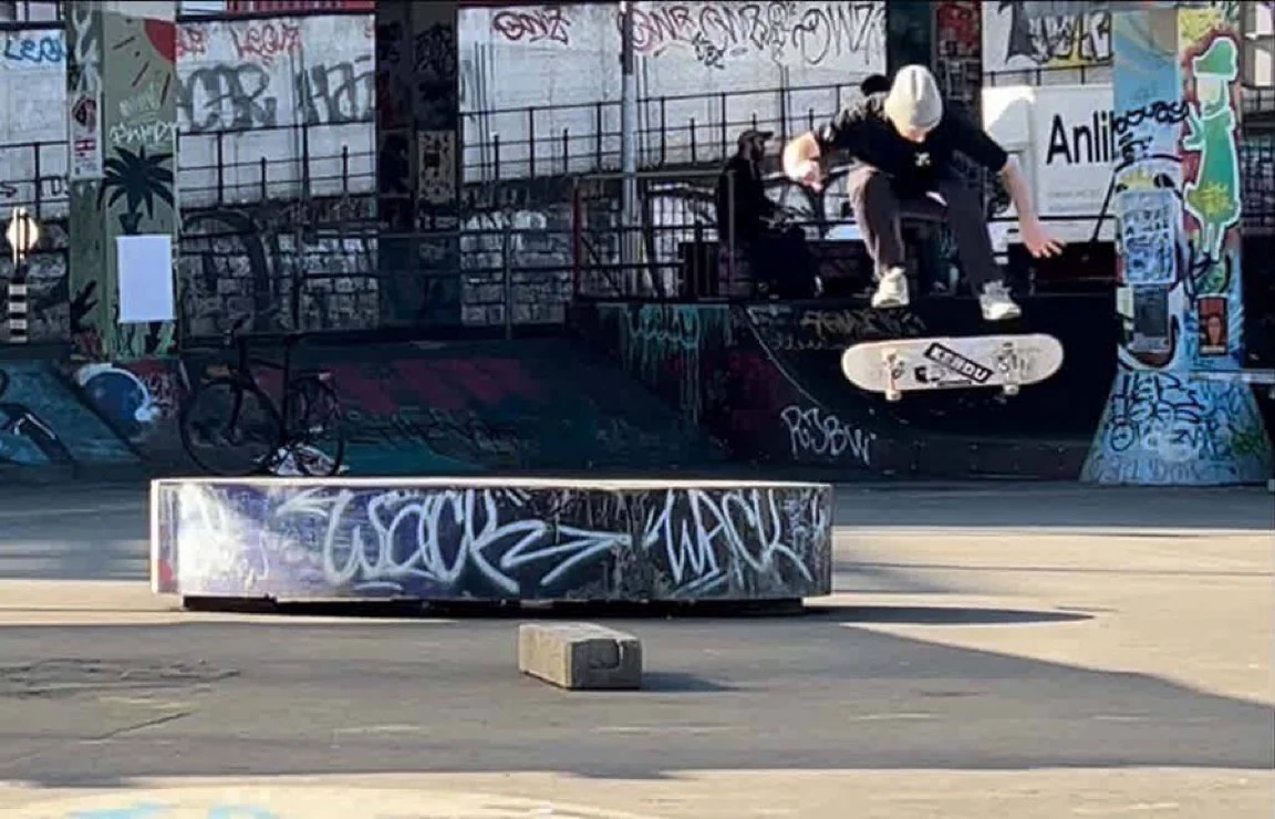 JD skateboarding at a graffiti-covered skatepark